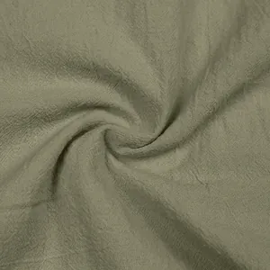 Detailed macro shot of breathable sage green linen fabric texture for men's casual suit