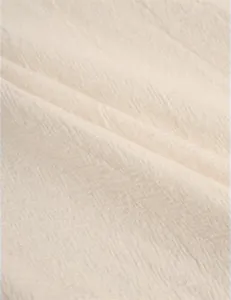 Close-up of breathable beige cotton linen fabric with natural woven texture