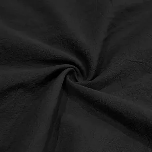 Close-up of breathable black linen fabric texture on casual men's summer shirt