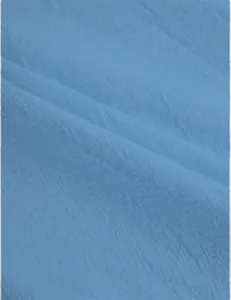 Close-up of breathable light blue cotton-linen fabric texture for men's casual pants