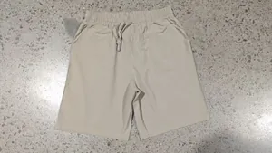 Men's casual linen drawstring shorts in solid beige color, ideal for summer beach wear