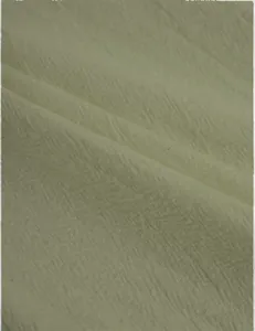 Close-up detail of breathable sage green linen fabric texture for casual trousers