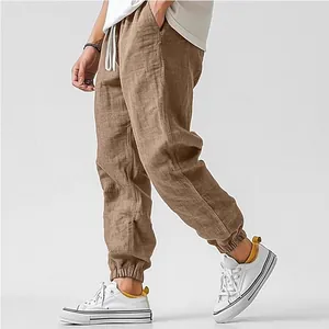 Close-up detail view of men's breathable linen jogger pants in brown with drawstring waist