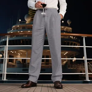 Elegant men's grey pinstriped linen straight suit trousers shown in a luxury cruise setting