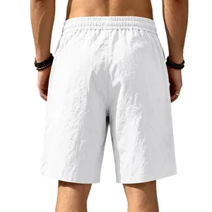 Back view detail of men's loose white linen cotton beach shorts with elastic waist