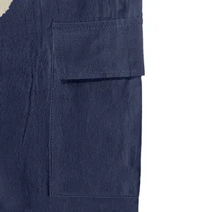 Detailed close-up of navy blue linen cargo pants showing pocket construction and fabric texture.