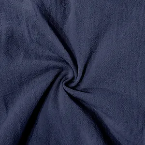 Macro detail shot showing the breathable navy blue linen fabric texture for men's summer trousers