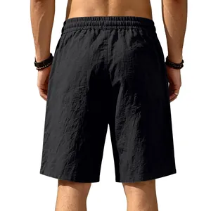 Back view detail of men's loose black linen shorts showing breathable fabric texture