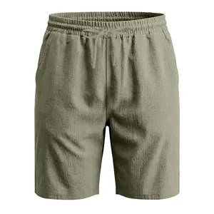 Detail of olive green men's linen shorts featuring a drawstring waist and breathable fabric