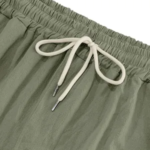 Close-up of men's olive green linen cargo pants waist with white drawstring