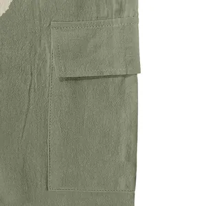 Close-up of green linen cargo pants showing the durable pocket design and fabric texture