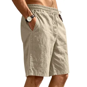 Close-up of men's breathable khaki linen beach shorts with elastic waist and drawstring.
