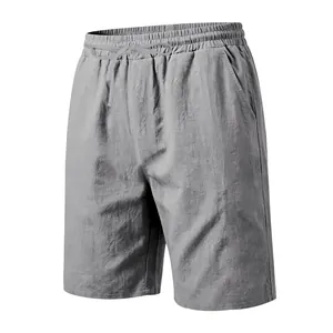 Close-up detail of grey men's linen shorts with drawstring waist and breathable cotton fabric.
