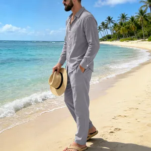Male model wearing grey linen long sleeve shirt and trousers on beach background