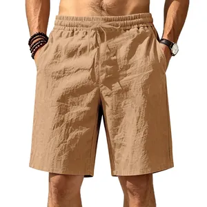 Detailed view of khaki linen shorts with elastic drawstring waist on model for beach wear