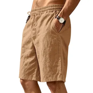 Close-up of tan linen shorts showing drawstring waistband and side pocket detail