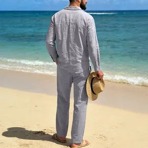 Back view of men's loose linen long sleeve shirt and pants beach set on sunny sand