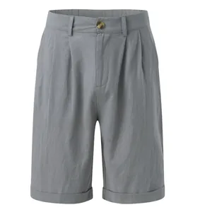 Detailed front view of grey pleated linen shorts for men in a straight leg style.
