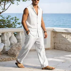 Detail of men's white linen sleeveless shirt and wide-leg trousers set for vacation.