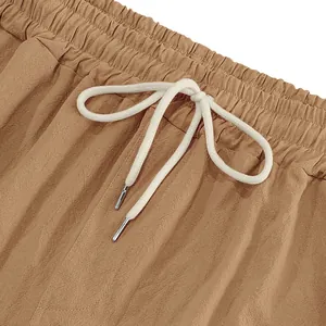 Close-up detail of khaki linen pants showing elastic waistband and drawstring