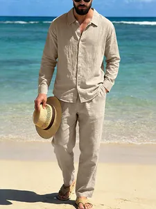 Men's casual linen beach set with long-sleeve shirt and trousers in beige on a beach.