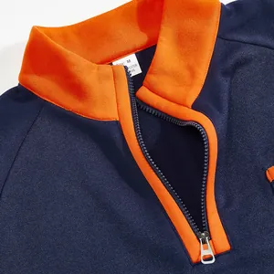Detailed view of heavy navy blue sweatshirt featuring a bright orange stand collar and zipper