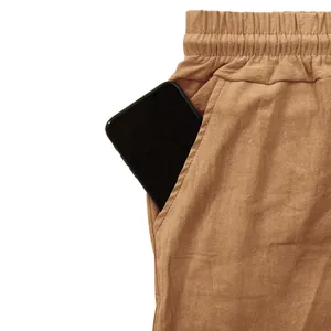Macro view of functional deep side pocket on men's breathable summer linen casual trousers