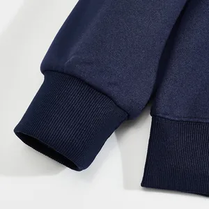 Detailed macro view showing the ribbed cuffs and soft fabric texture of navy blue sweatshirt