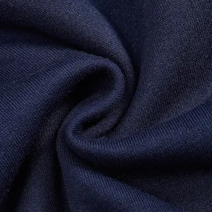 Macro shot of heavy navy blue warm fleece fabric texture for men's sweatshirt.