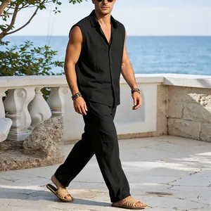 Men's black linen sleeveless shirt and pants set shown in a coastal vacation setting