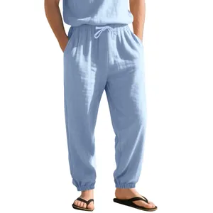 Full view of light blue linen jogger pants on a male model for summer casual wear