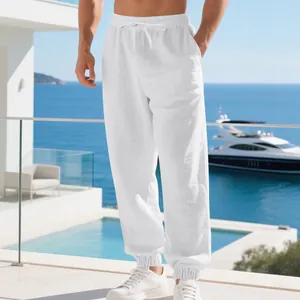 Macro view of men's breathable white linen joggers showcasing the drawstring waist design