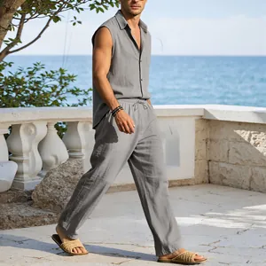 Full body shot of man wearing a gray linen sleeveless shirt and trousers set for beach resort