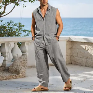 Casual grey linen sleeveless shirt and trousers set for men in a coastal resort setting.