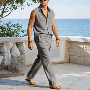 Man wearing a casual grey sleeveless cotton linen shirt and trousers set by the seaside resort