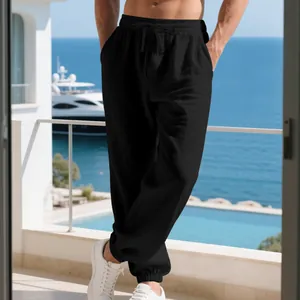 Detail view of men's black linen casual joggers with drawstring waist and elastic cuffs