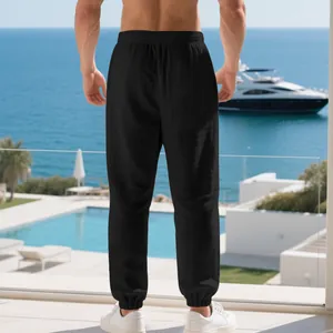 Detailed back view of men's loose black linen joggers with elasticated waist and ankle cuffs
