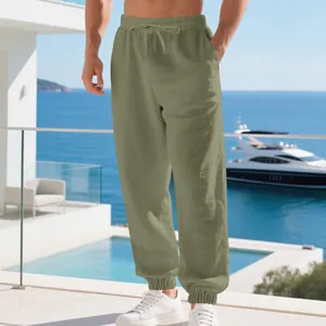Olive green men's linen joggers with drawstring waist and cuffed ankles