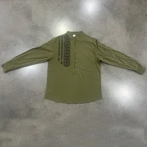 Detailed view of an olive green linen Henley shirt with vertical black ethnic print