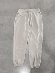 Close-up detail of breathable beige linen jogger pants featuring a drawstring waistband.
