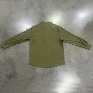 Back view of a relaxed fit men's olive green linen Henley shirt with a mandarin collar