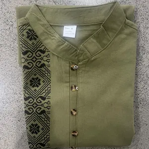 Detail of olive green linen Henley shirt with ethnic geometric print and stand collar