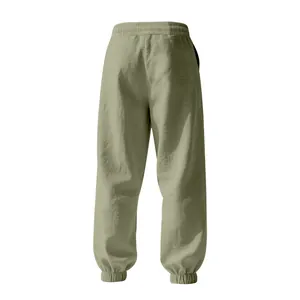 Back view detail of breathable men's linen loose joggers in sage green color