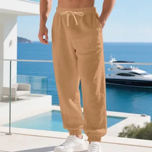 Detailed view of breathable men's linen jogger pants styled in a sunny beach resort setting