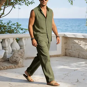 Male model wearing olive green linen sleeveless shirt and trousers set on a seaside terrace