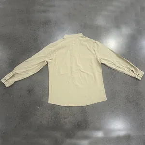 Back view of men's loose fit linen long-sleeved shirt in beige with a stand collar
