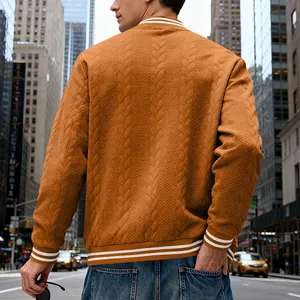 Detailed rear view of brown cable-knit varsity jacket with striped ribbed hem and cuffs