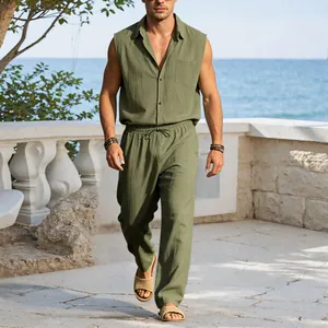 Close-up view of a man wearing a green linen sleeveless shirt and trousers set at the beach