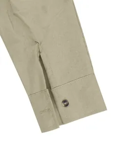 Close-up macro view of a men's linen Henley shirt cuff with marble pattern button
