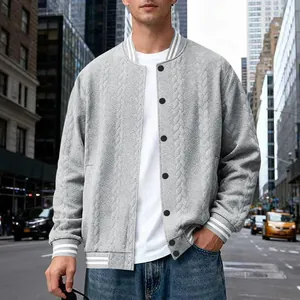 Close-up detail of men's grey knitted bomber jacket featuring striped ribbed trim.